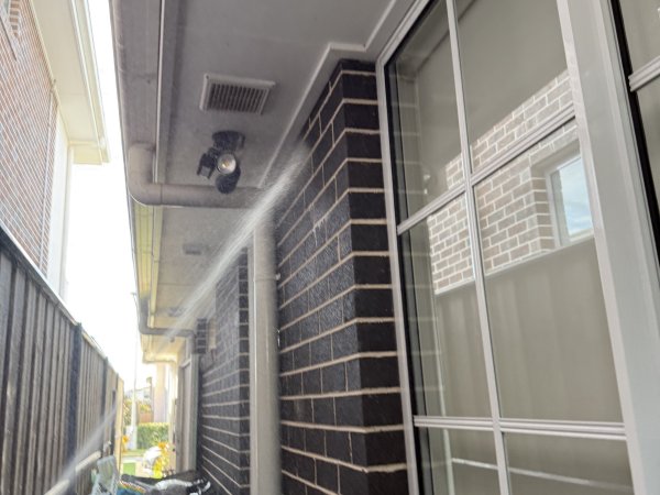 Perimeter spray applied along the side of a brick home