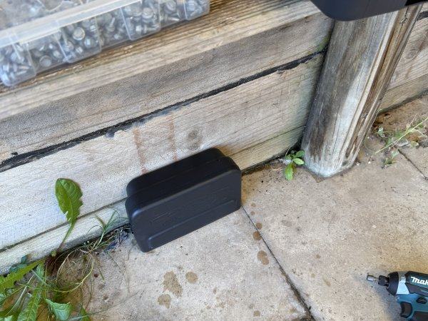 Lockable rodent bait station placed along an external wall for rat and mouse control