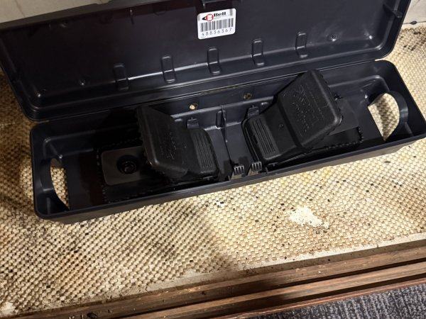 Snap traps set inside a tamper-resistant rodent station at a doorway